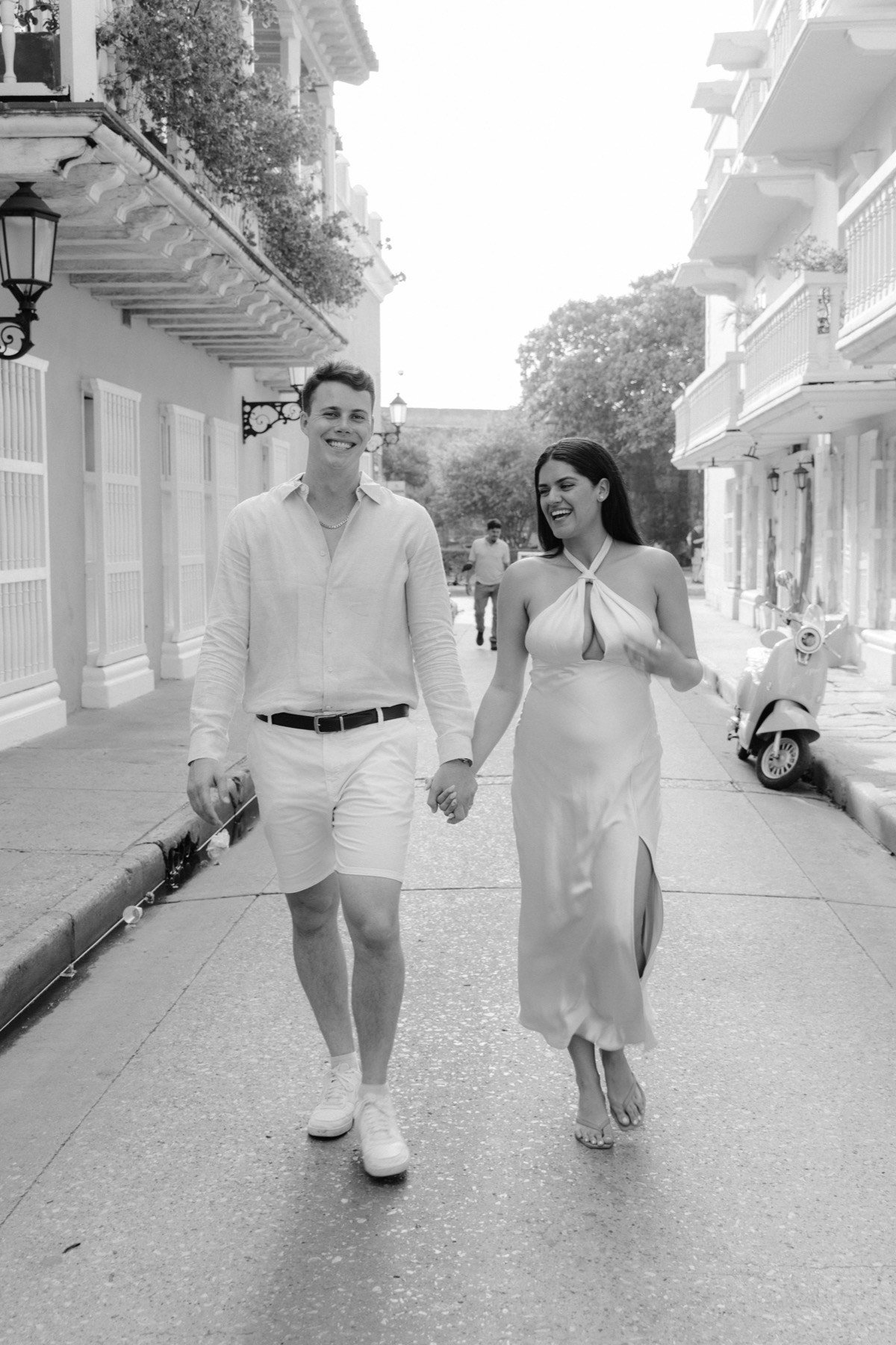 Couple walking hand in hand down a colonial street in Cartagena's walled city