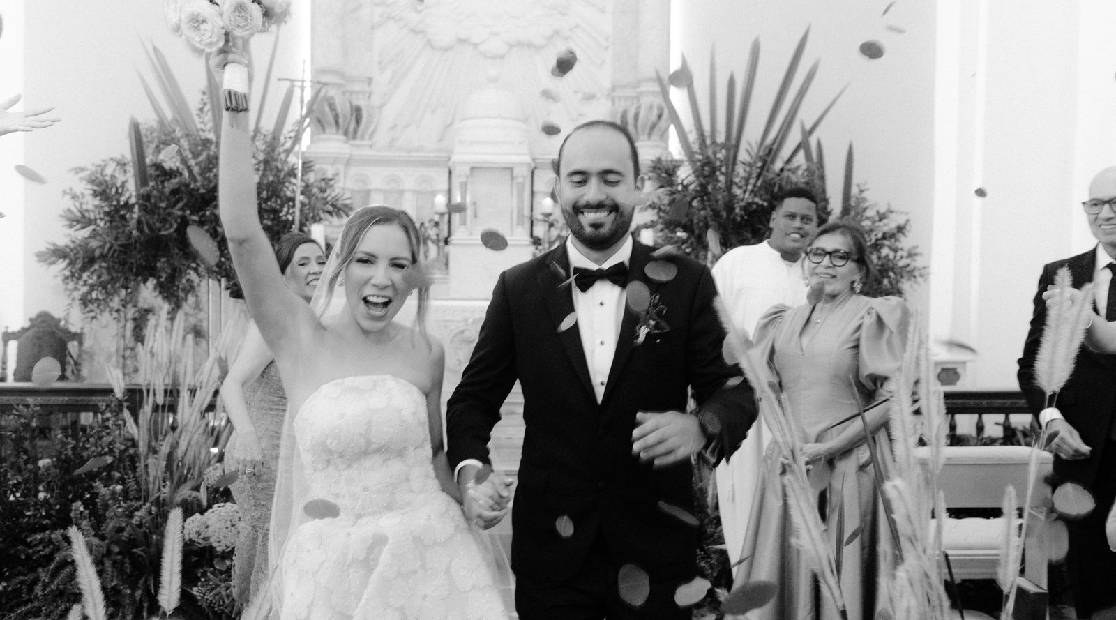 Joyful Cartagena wedding recessional — guests celebrating a destination wedding couple