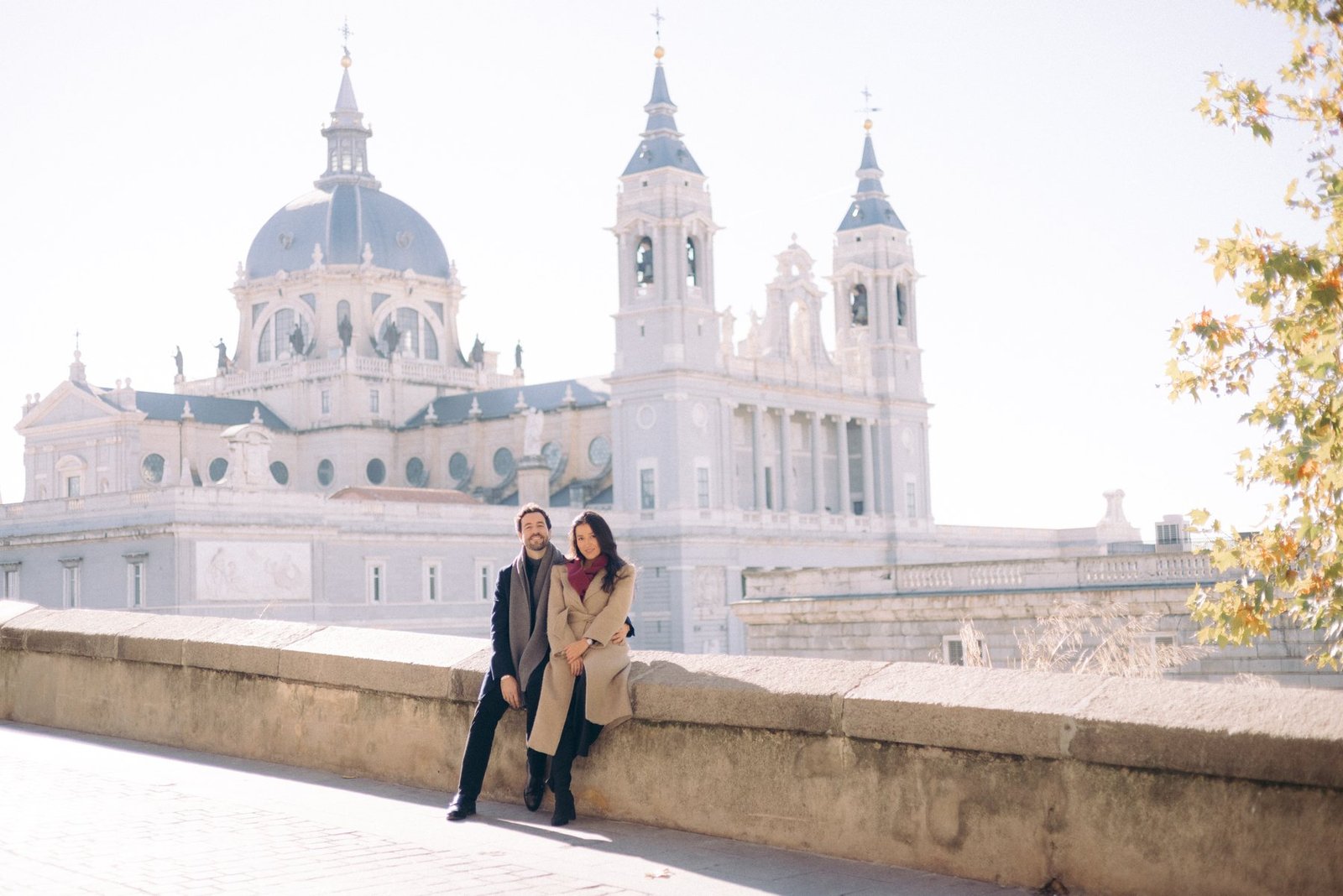 Editorial wedding photography — wide view of a couple before a cathedral dome
