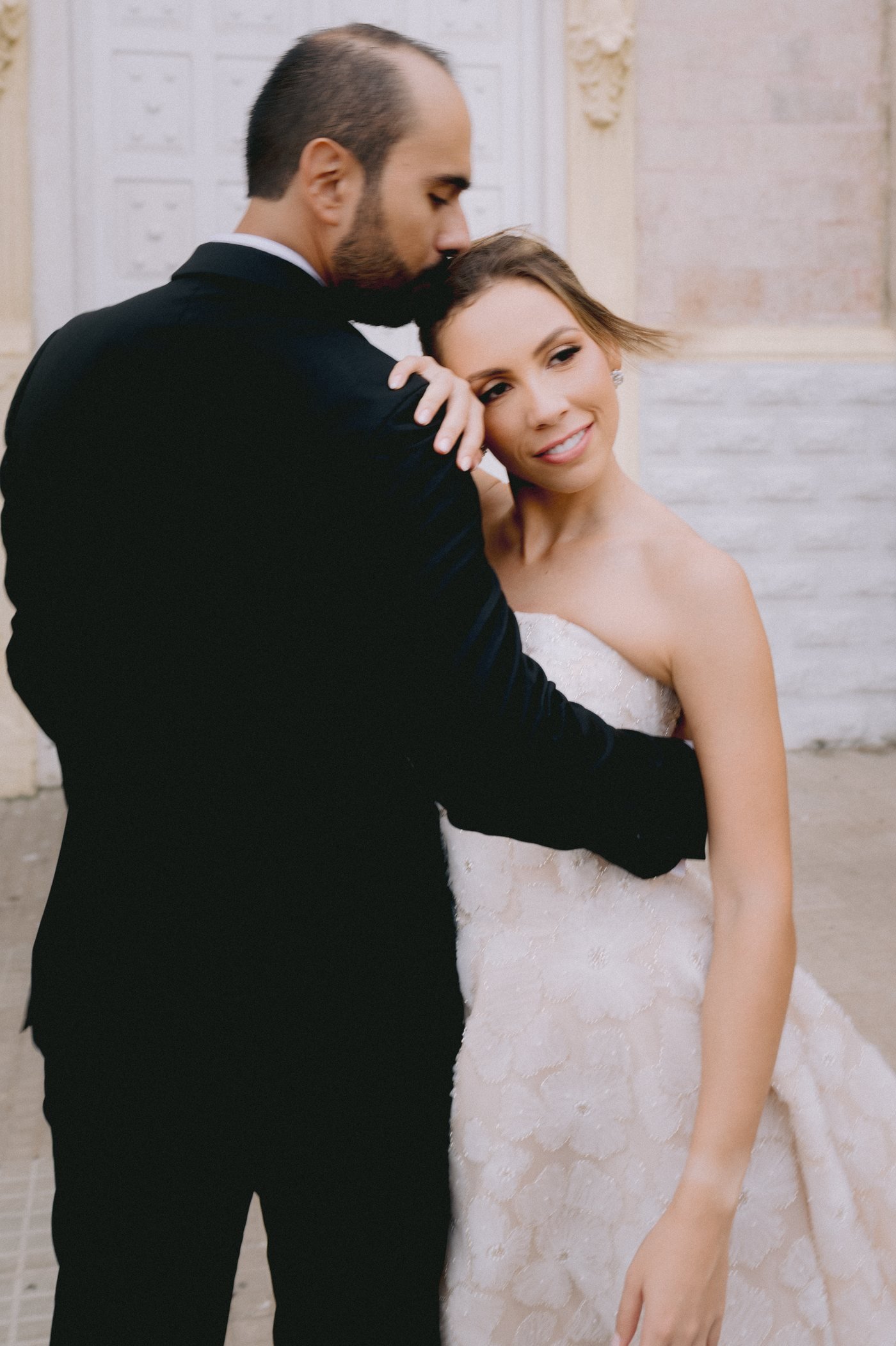 Cartagena wedding photography — groom embracing bride, editorial couple portrait