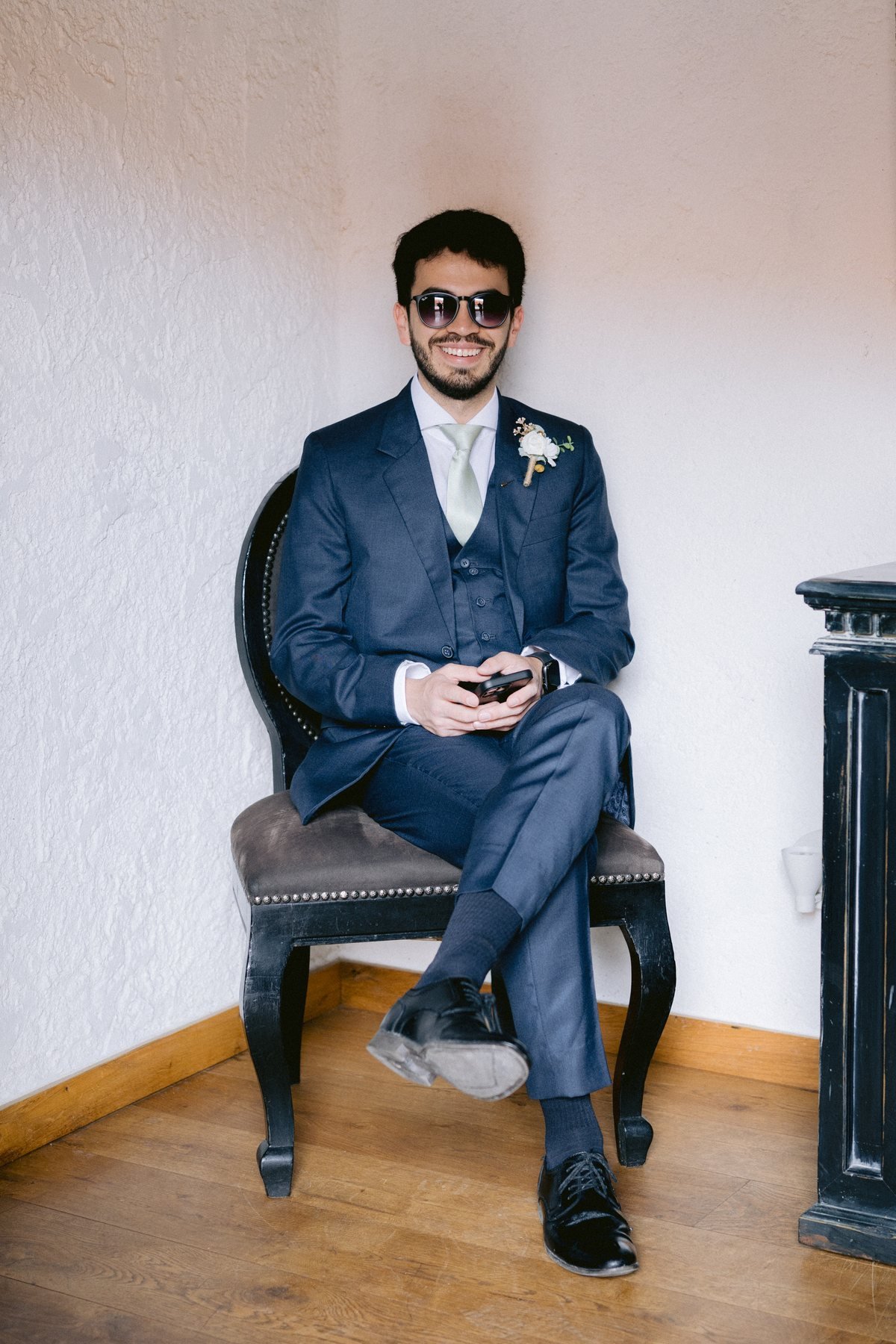 Fashion-forward editorial groom portrait in sunglasses