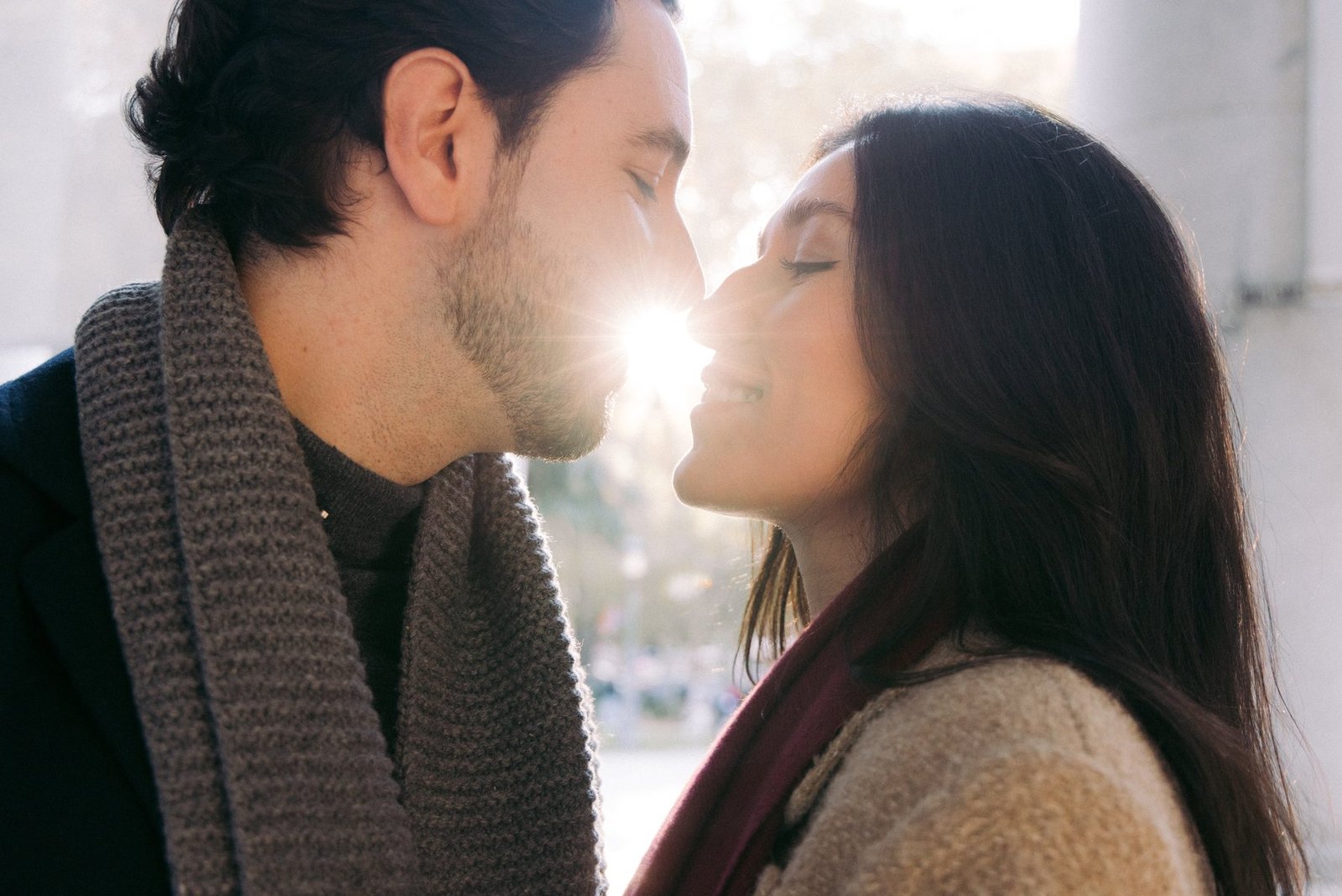 Close-up editorial profile portrait of a couple kissing