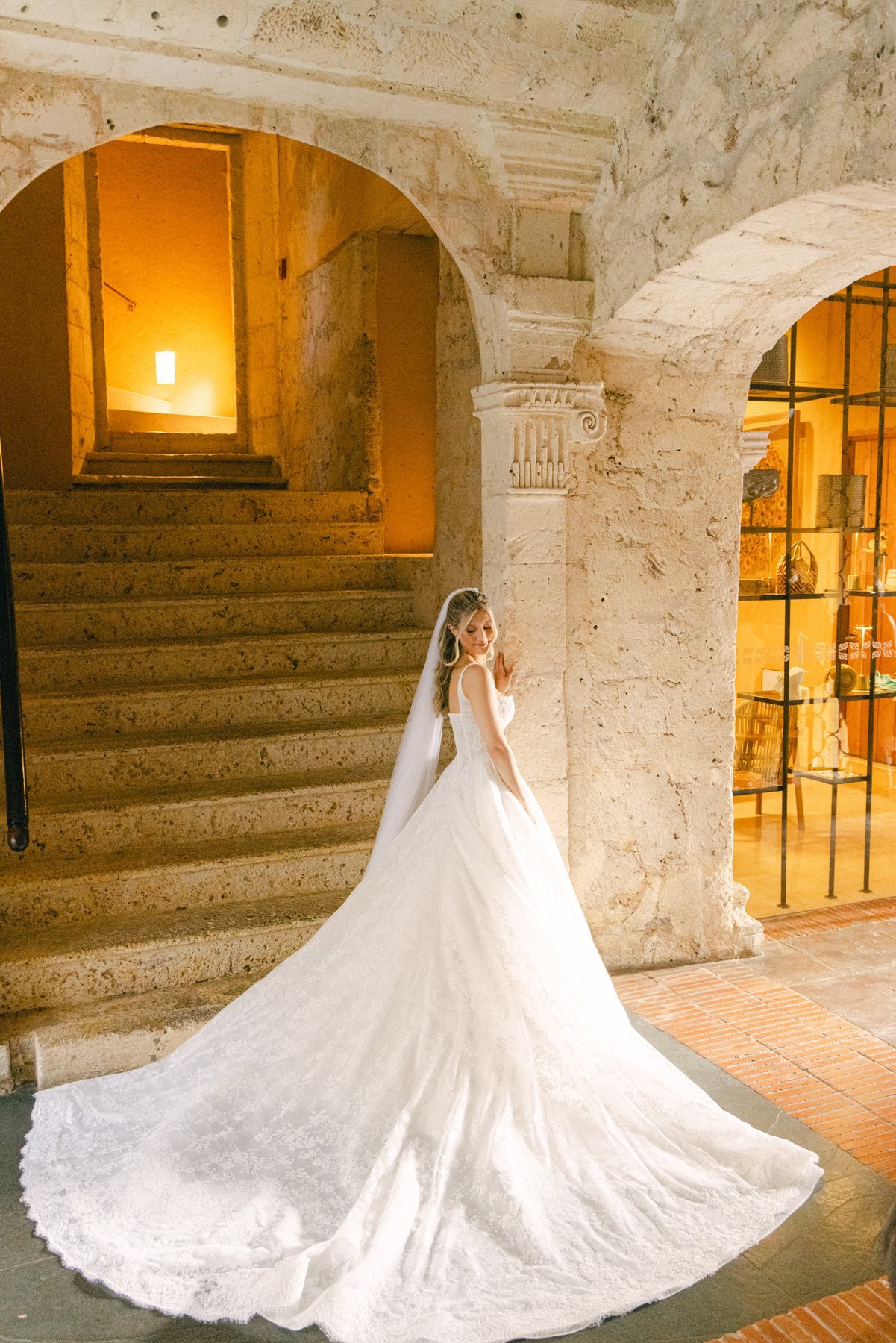 Bride's veil trailing beside a vintage convertible, editorial wedding photography