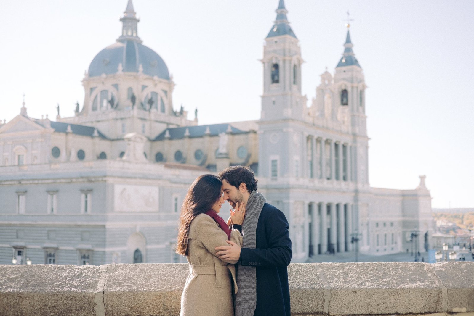 Editorial wedding photography — couple kissing before a golden hour cathedral
