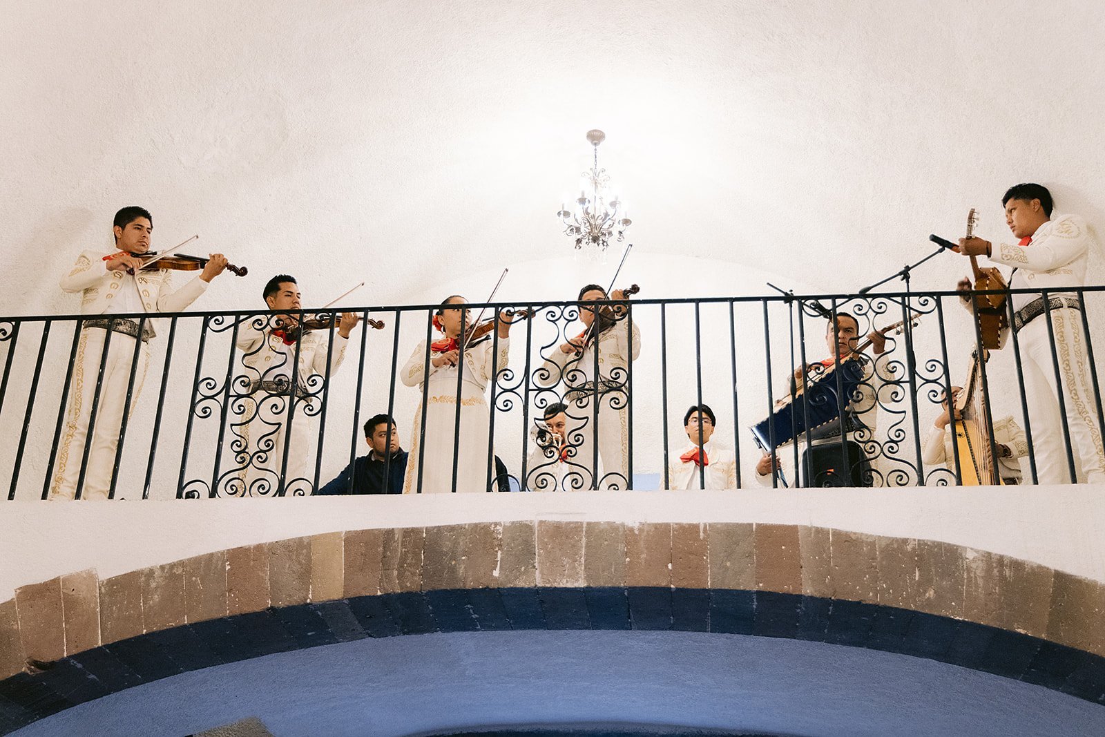 Wedding guests gathered on a balcony staircase