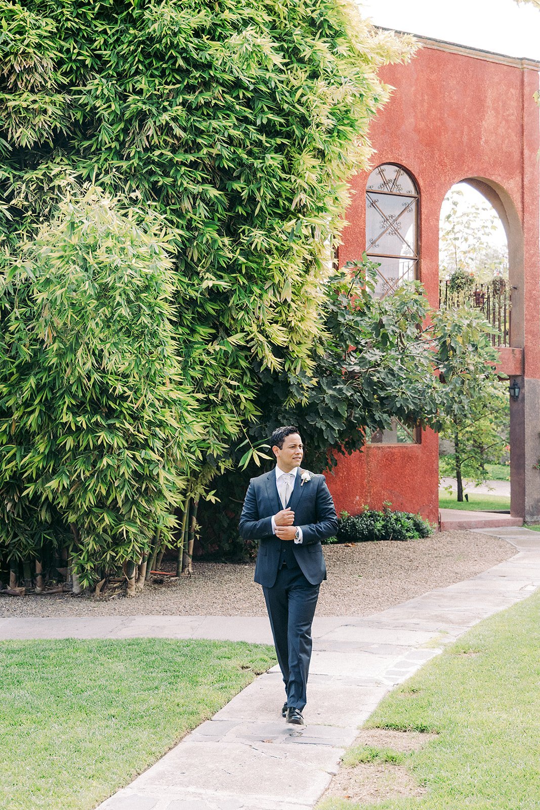 Said walking through a colonial garden pathway before the ceremony