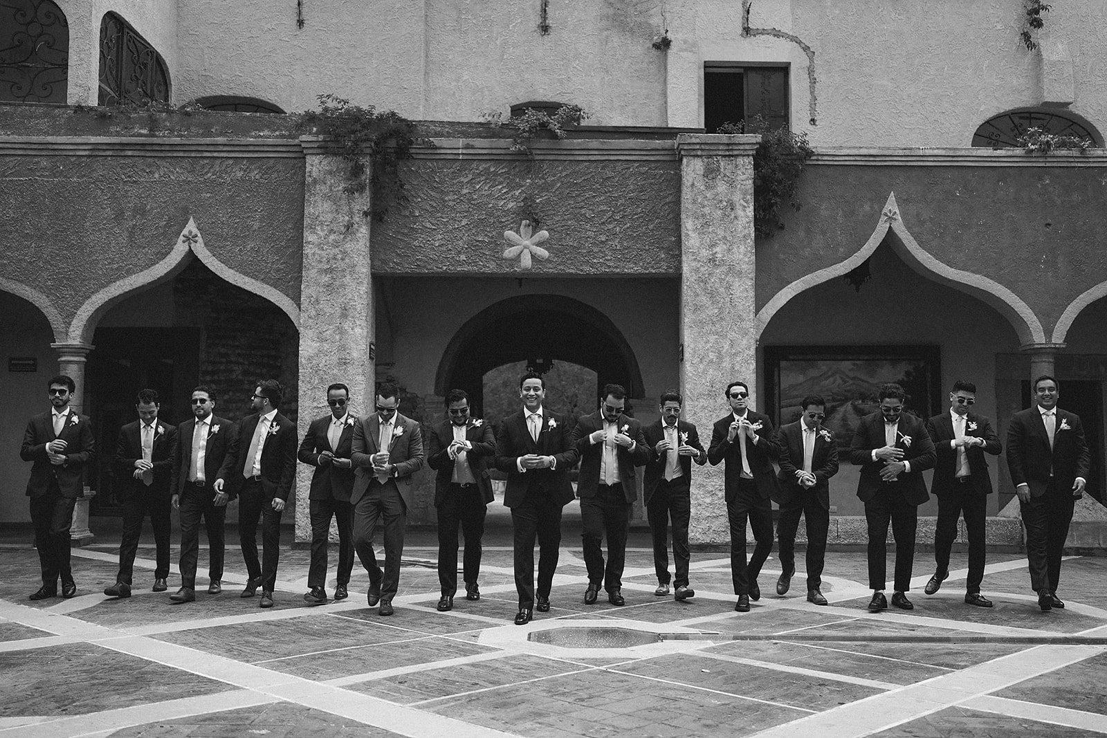 Groomsmen lined up outside the church facade in San Miguel de Allende