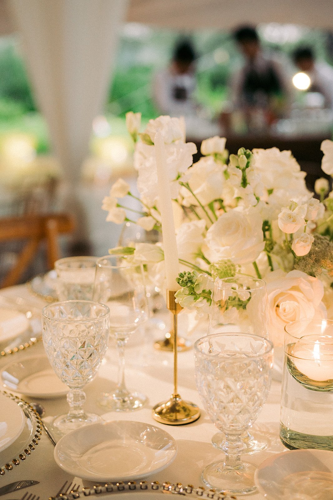 Reception table setting with candles and white florals